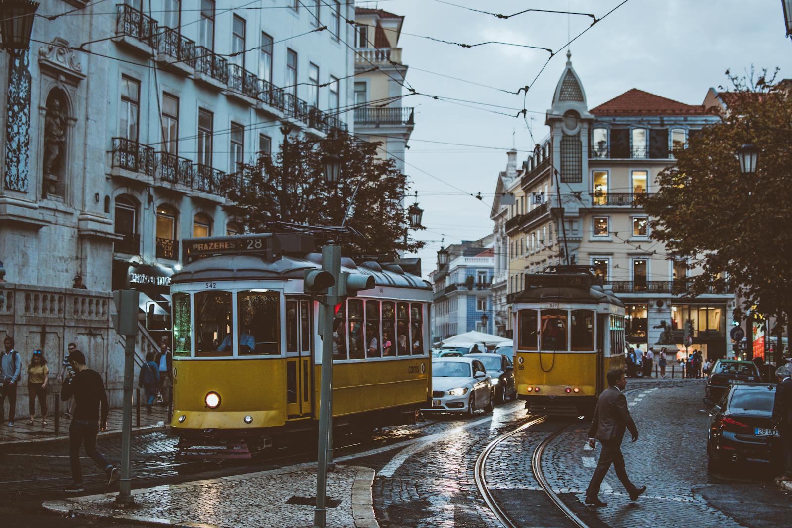 Colorful buildings along Lisbon waterfront with traditional tram